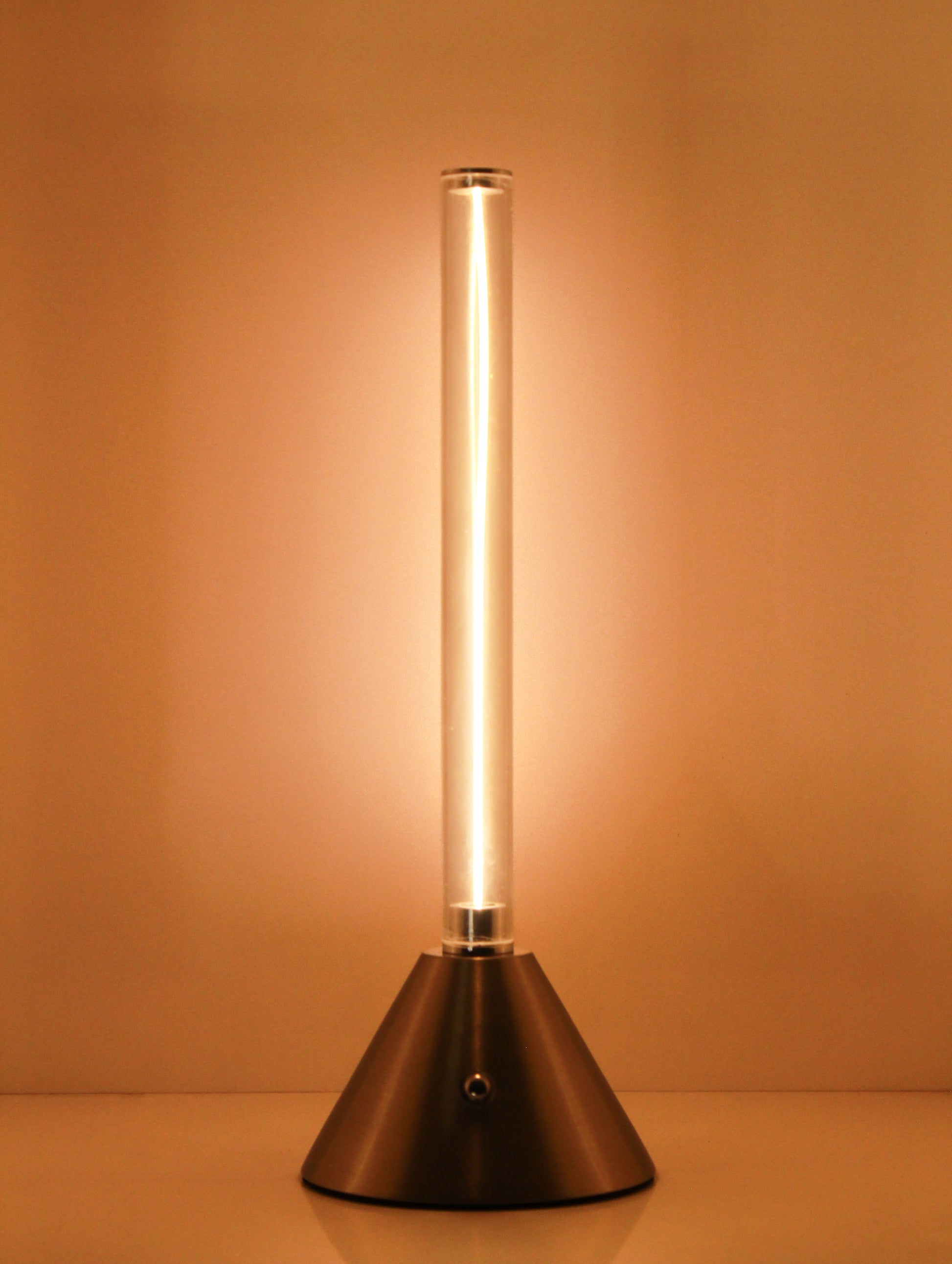 Metal Touch Modern cylindrical light fixture on a Plain background