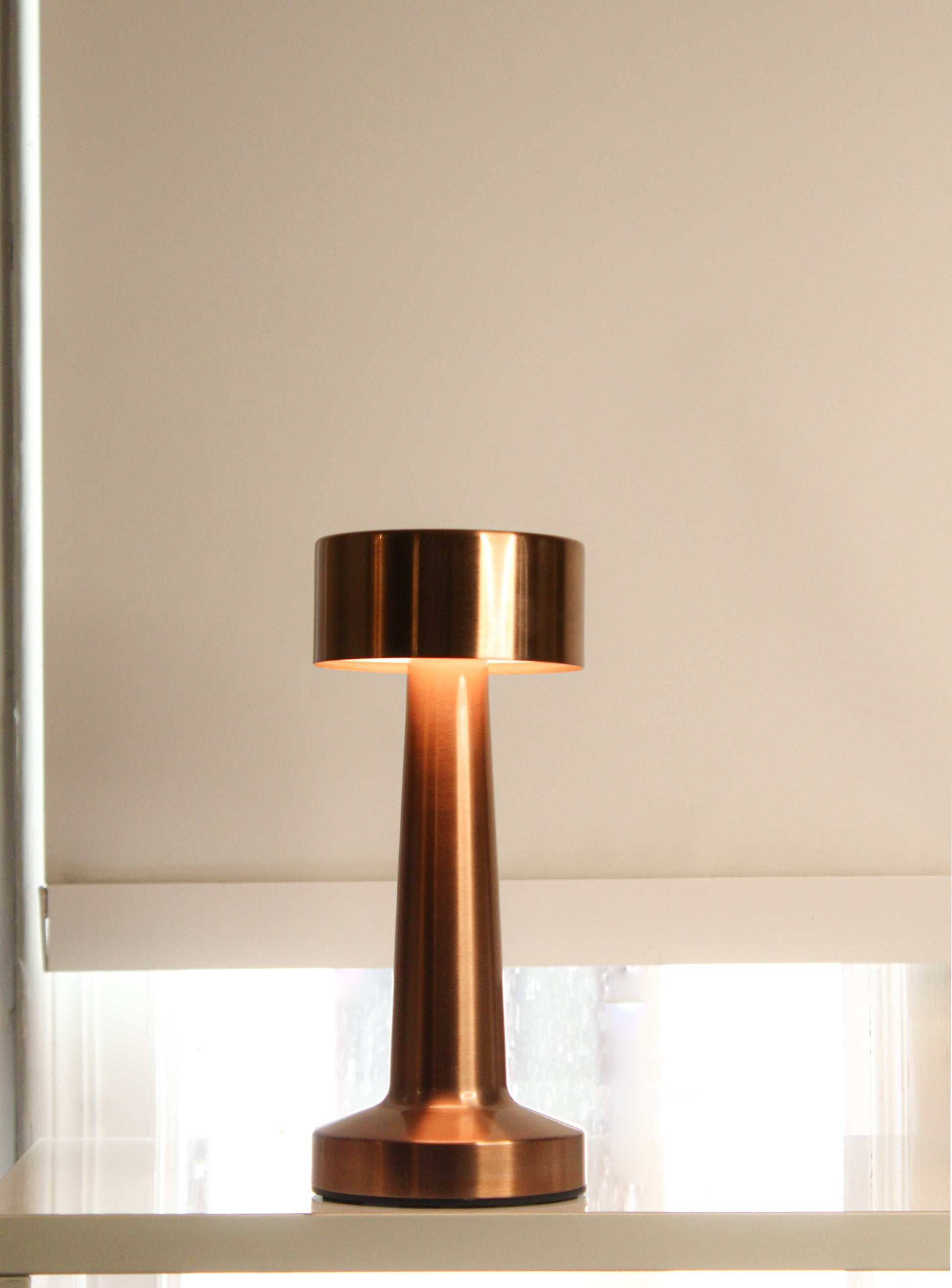 Retro Dune Descent Metal Lamp - Close-up of the champagne brass finish and touch-sensor interface on the Garnish Retro Dune Descent metal lamp.