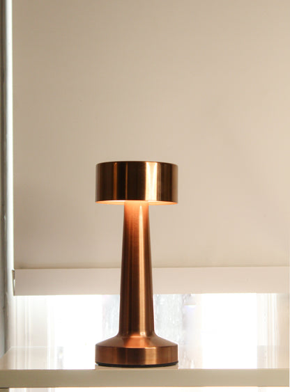 Retro Dune Descent Metal Lamp - Close-up of the champagne brass finish and touch-sensor interface on the Garnish Retro Dune Descent metal lamp.