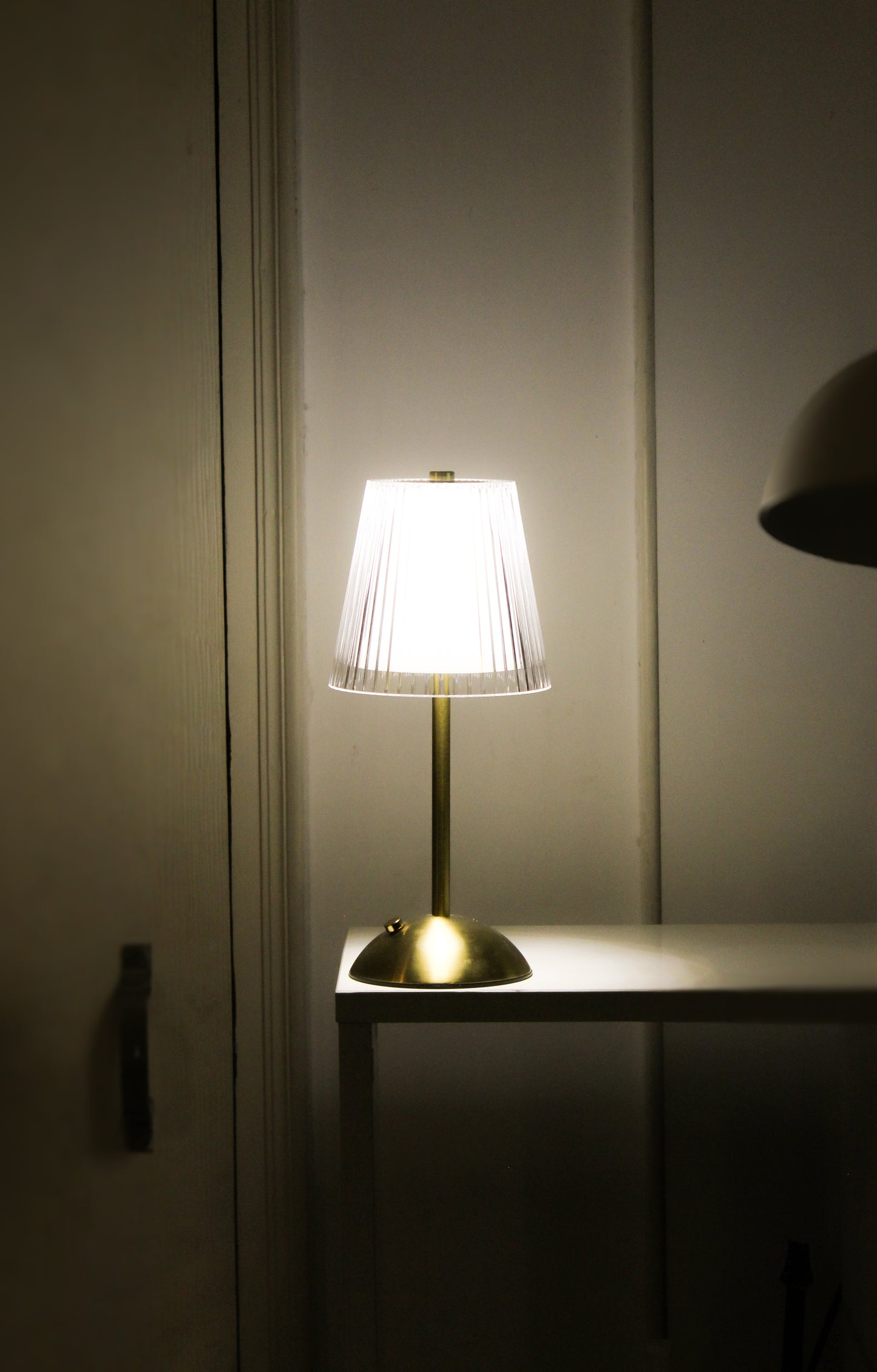 Side profile of the Prism Glaze metal lamp showing its unique architectural silhouette.