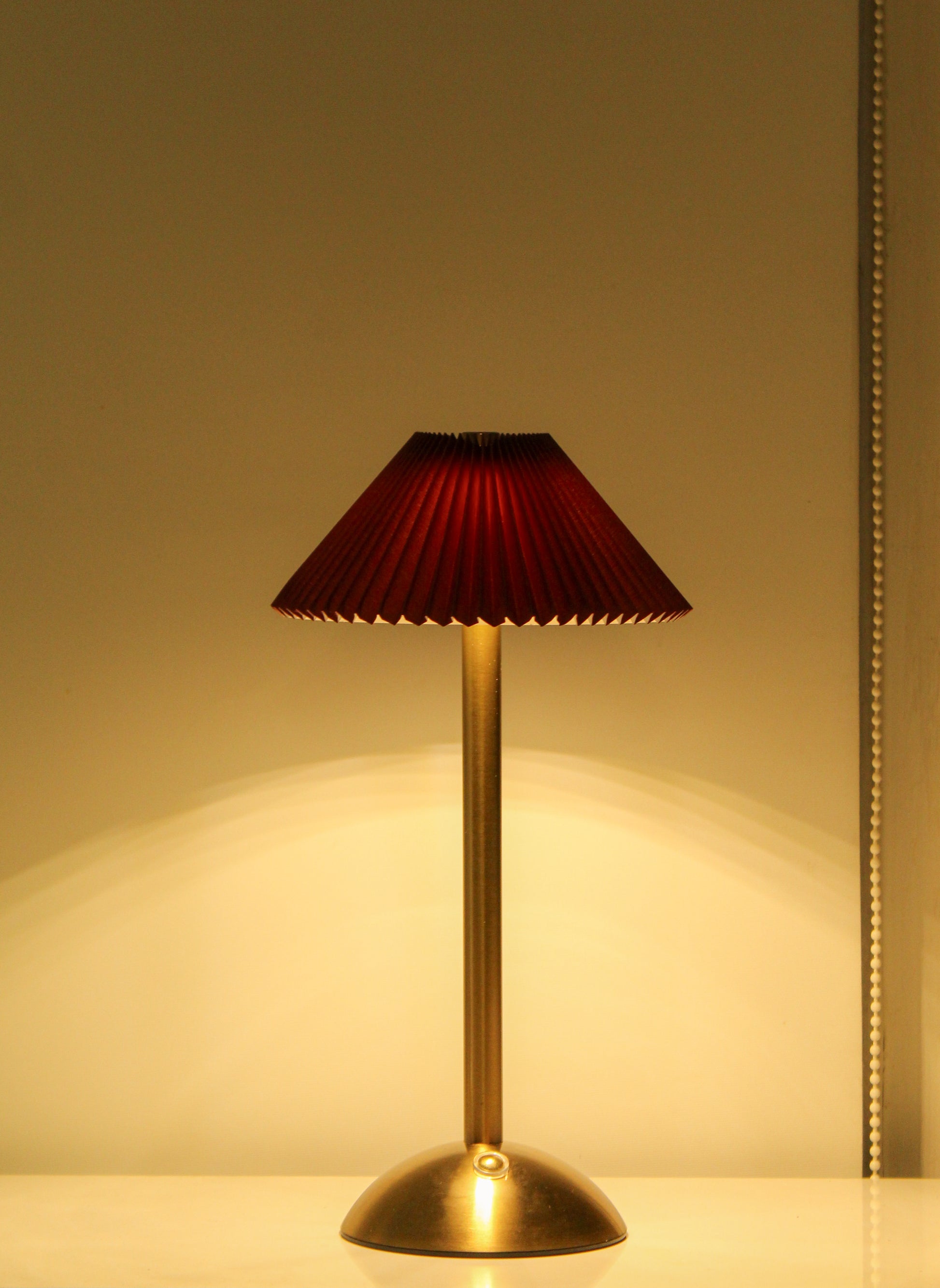 Clean side view of the Velvet Kasa lamp highlighting its seamless metal construction.