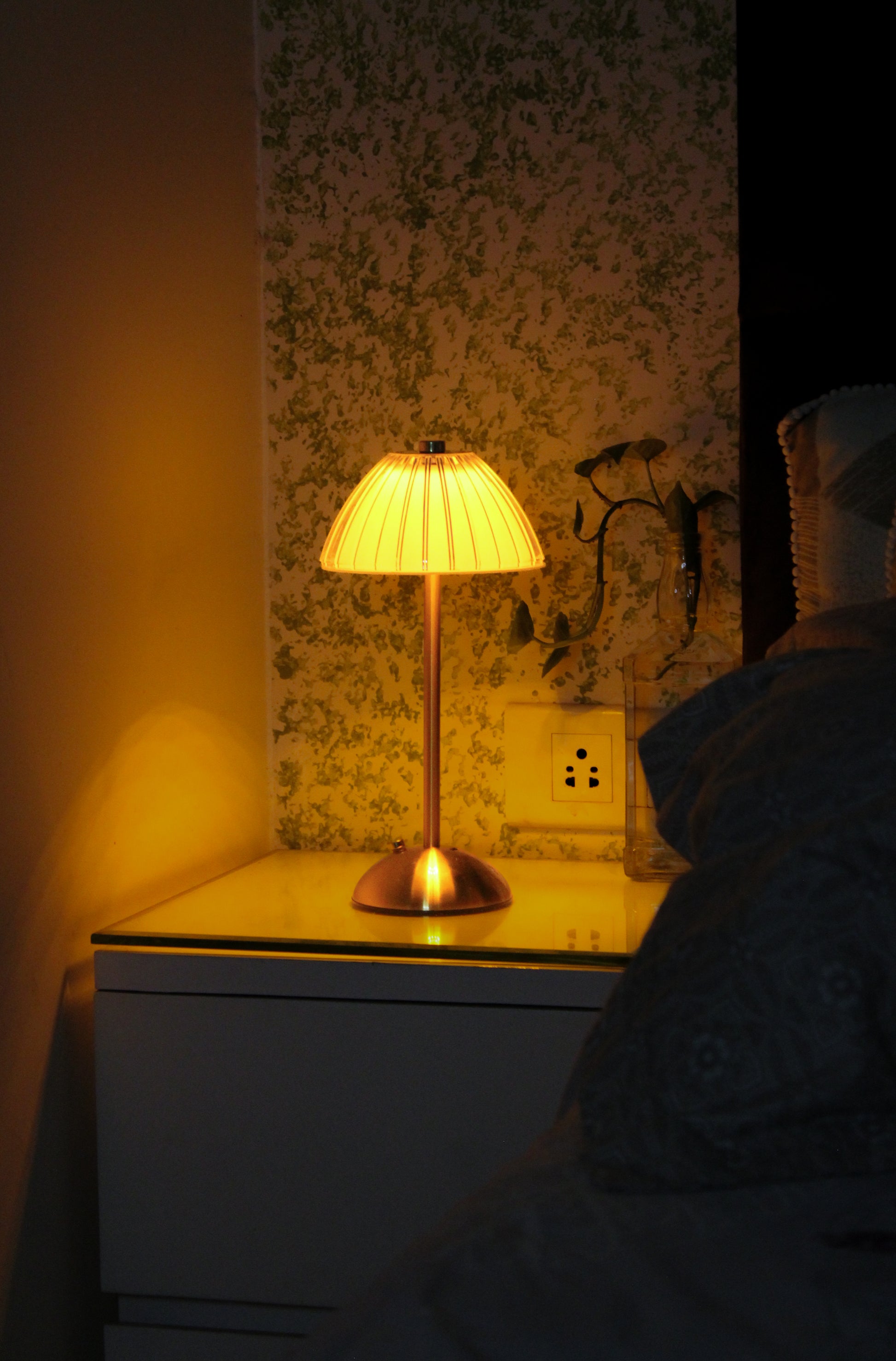 Aura Ember by Garnish, a luxury champagne brass cordless lamp providing a warm ambient glow.