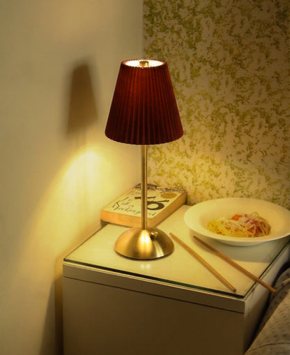 The Gazing Velvet Kasa cordless lamp placed on a wooden nightstand for aesthetic home decor.