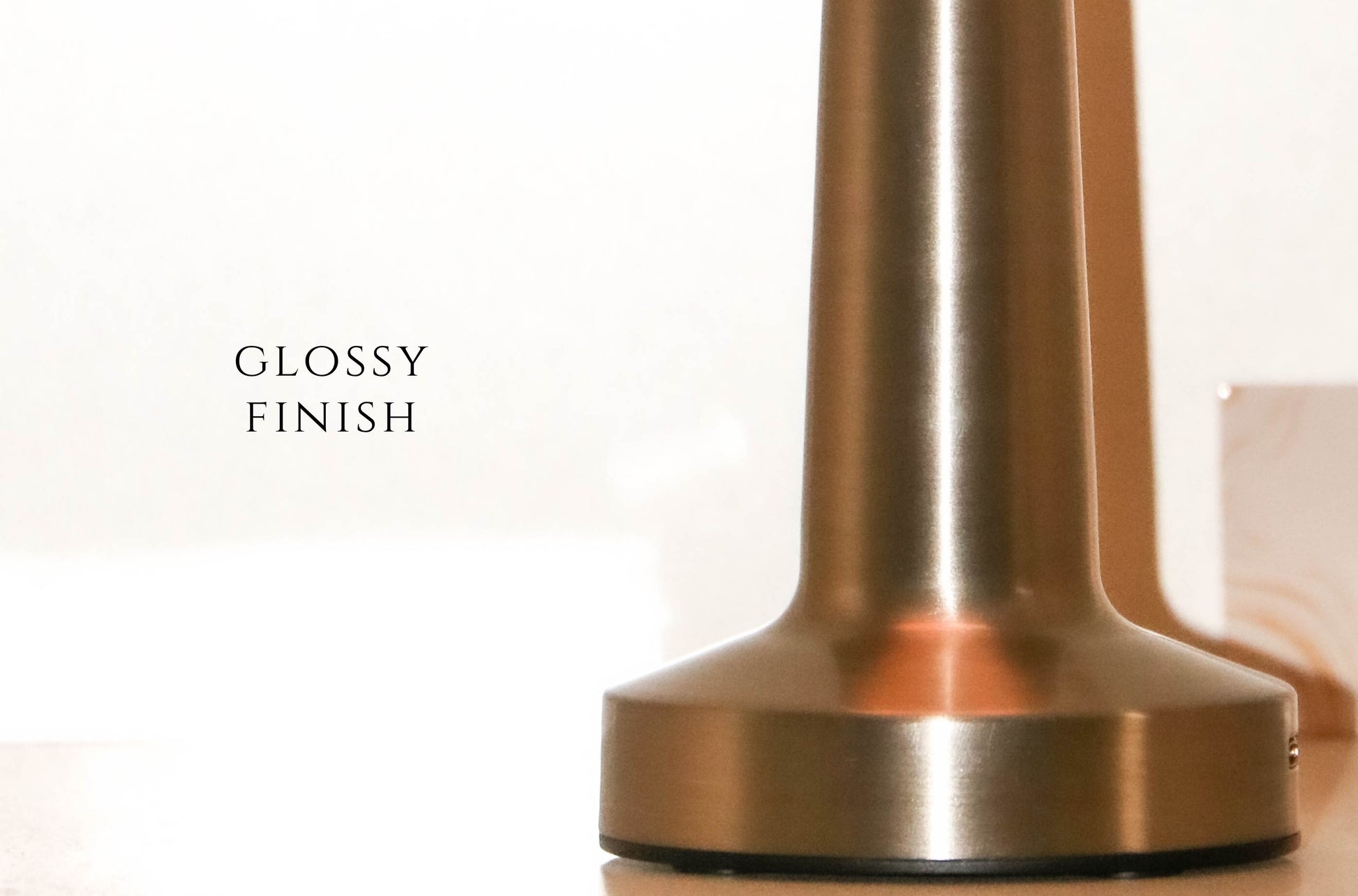Detailed shot of the champagne brass base and touch interface of the Retro Dune lamp.